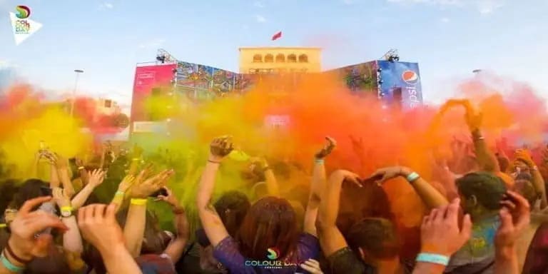 People dancing in powder colors