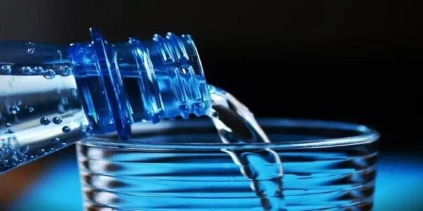 blue waterbottle and glass on black backround